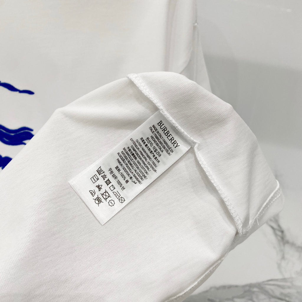 White T-shirt care label and size tag on interior neckline area.