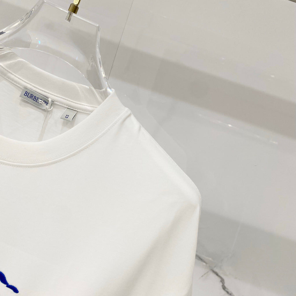 White crew-neck T-shirt with brand label at collar, close-up on hanger.
