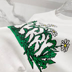 White short-sleeve T-shirt with large green foliage and white flower print
