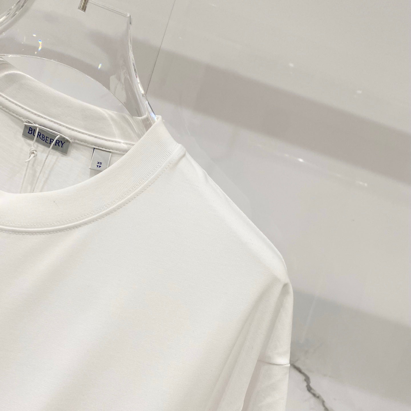 White short-sleeve T-shirt with round crew neck and small inner label