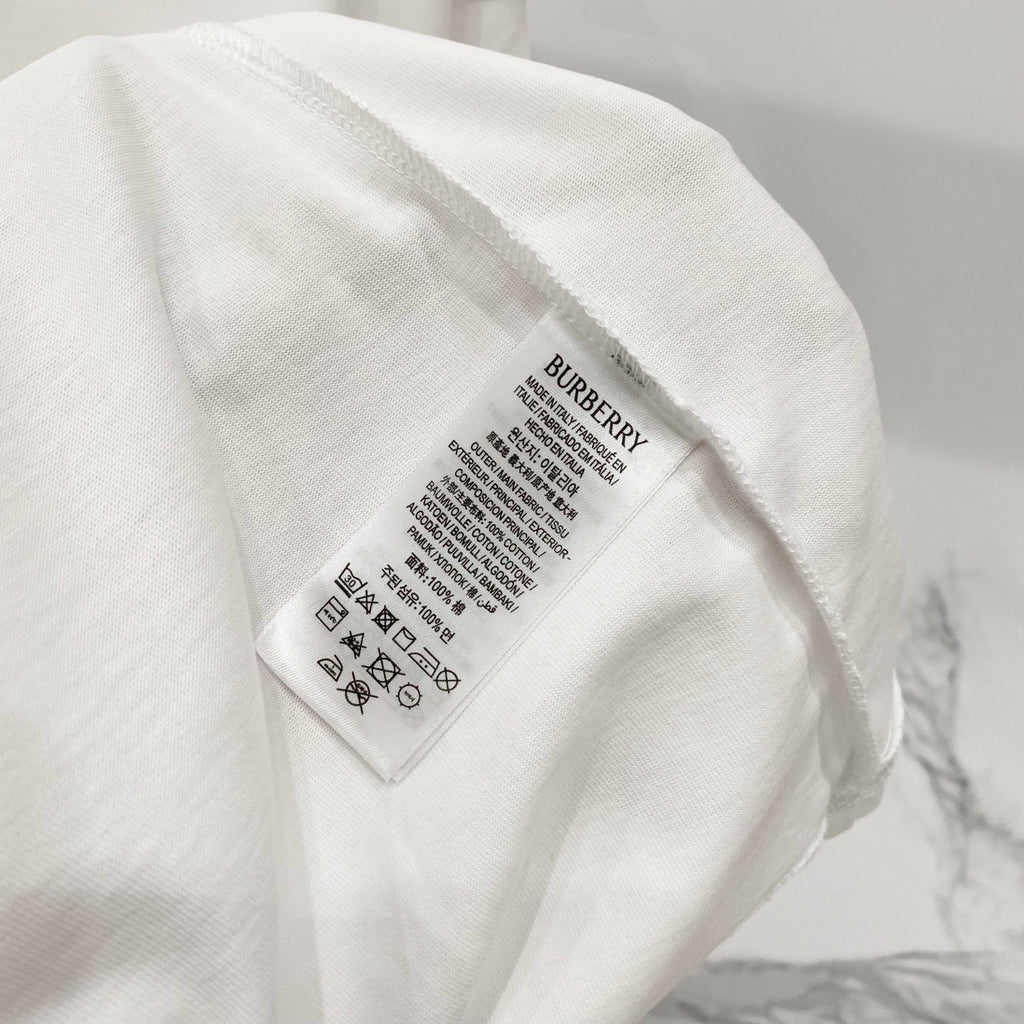 White short-sleeve T-shirt care label with Burberry branding on inner tag