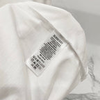 White short-sleeve T-shirt care label with Burberry branding on inner tag