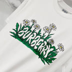 White short-sleeve T-shirt with green foliage and white daisy flower print