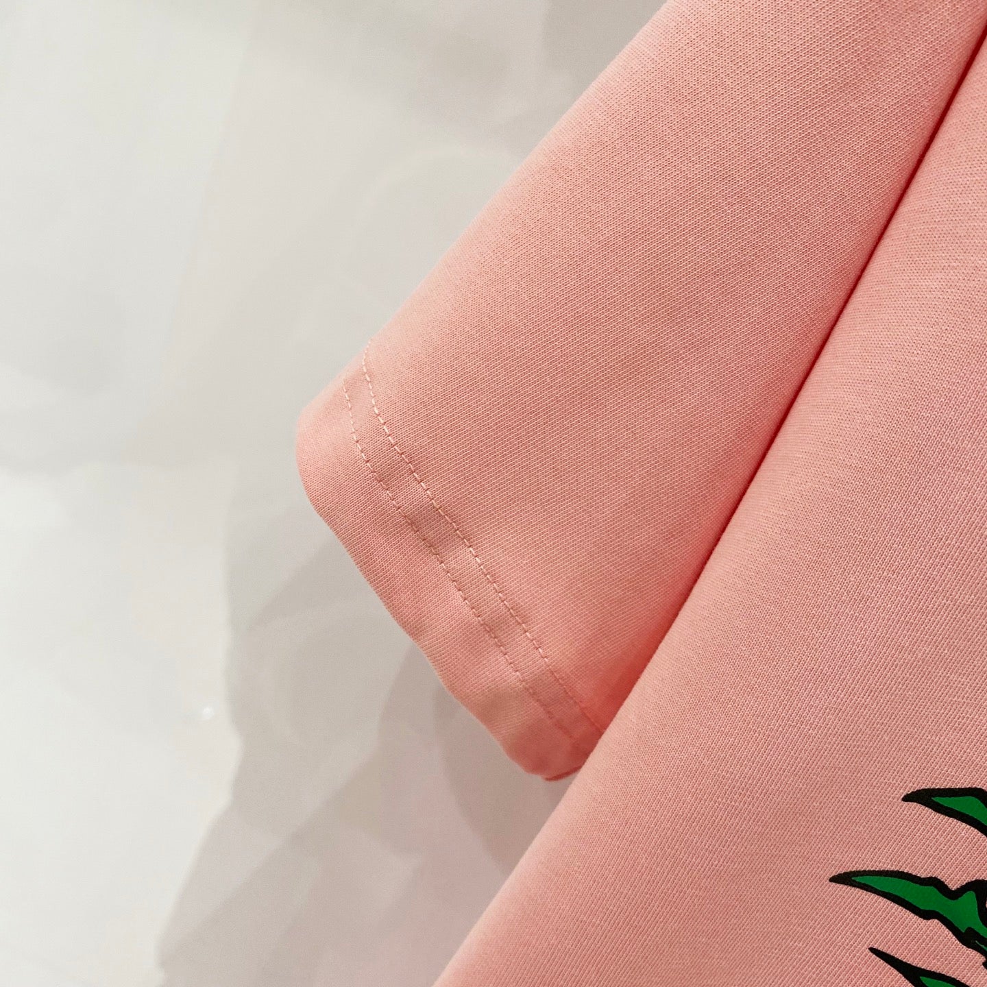 Pink Burberry T-shirt sleeve hem stitching detail.
