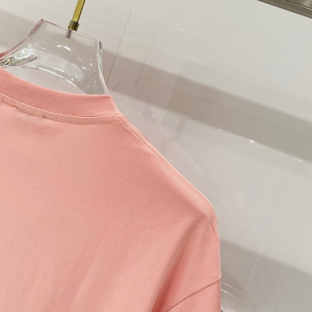 Pink Burberry T-shirt side seam and hem area detail.