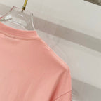 Pink Burberry T-shirt side seam and hem area detail.