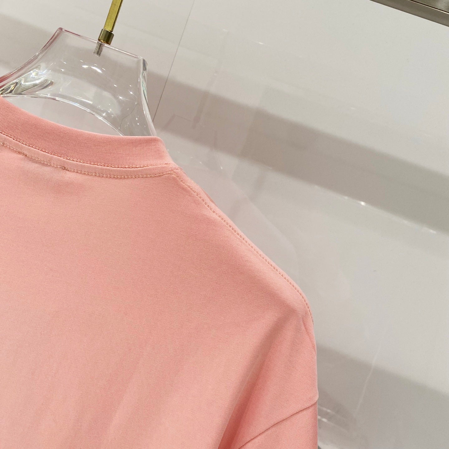 Pink Burberry T-shirt side seam and hem area detail.