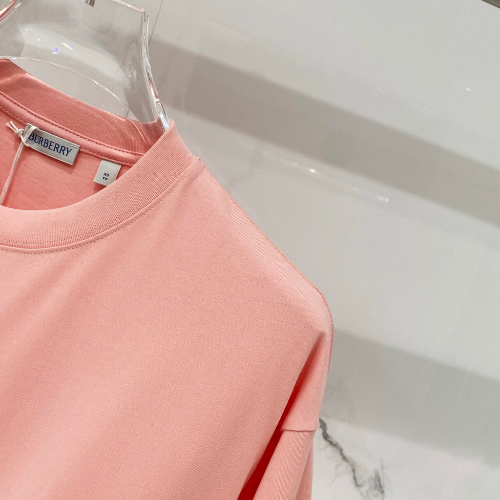 Pink Burberry T-shirt shoulder and sleeve seam detail.