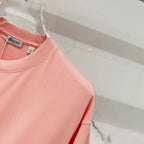 Pink Burberry T-shirt shoulder and sleeve seam detail.