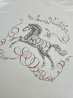 Louis Vuitton white T-shirt with ornate red cursive and black emblem graphic