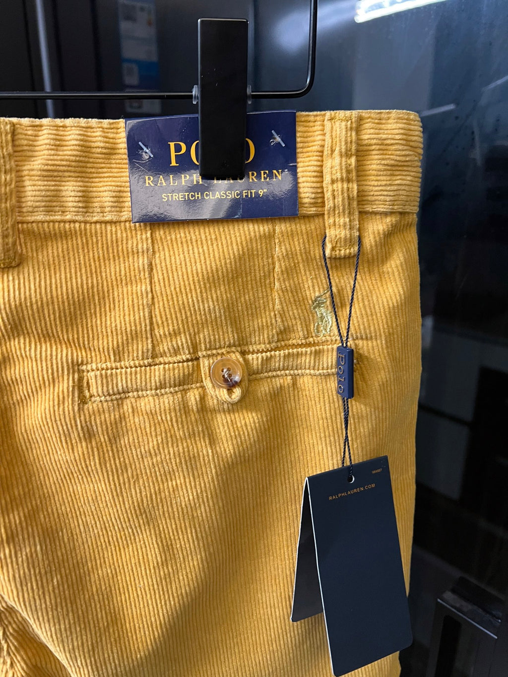 Ralph Lauren light mustard pants with Polo Ralph Lauren label at waistband