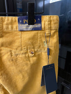 Ralph Lauren light mustard pants with Polo Ralph Lauren label at waistband