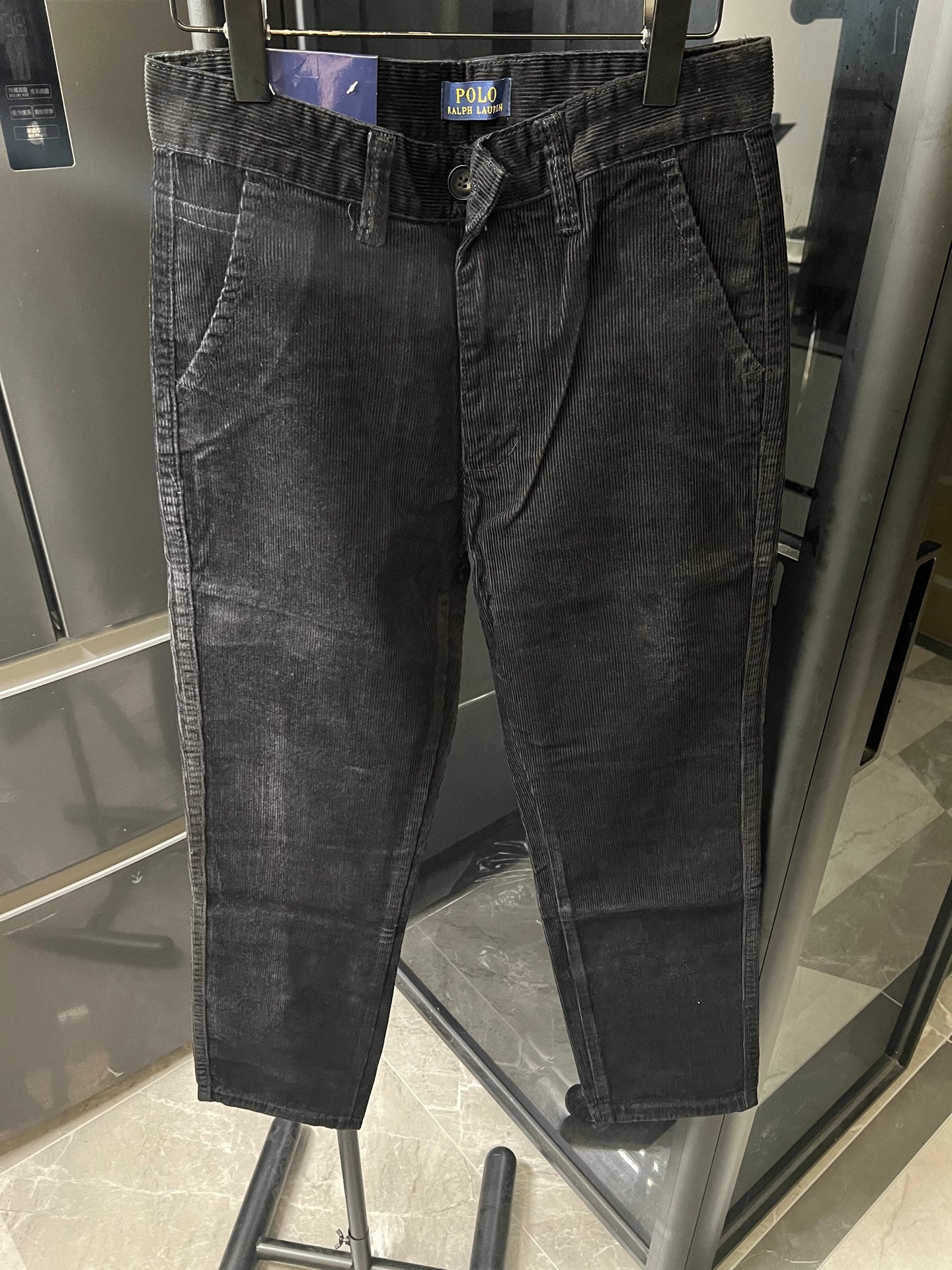 Dark corduroy jeans with pleated front and straight legs