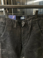 Corduroy jeans waistband with button fly, belt loops, and brand patch