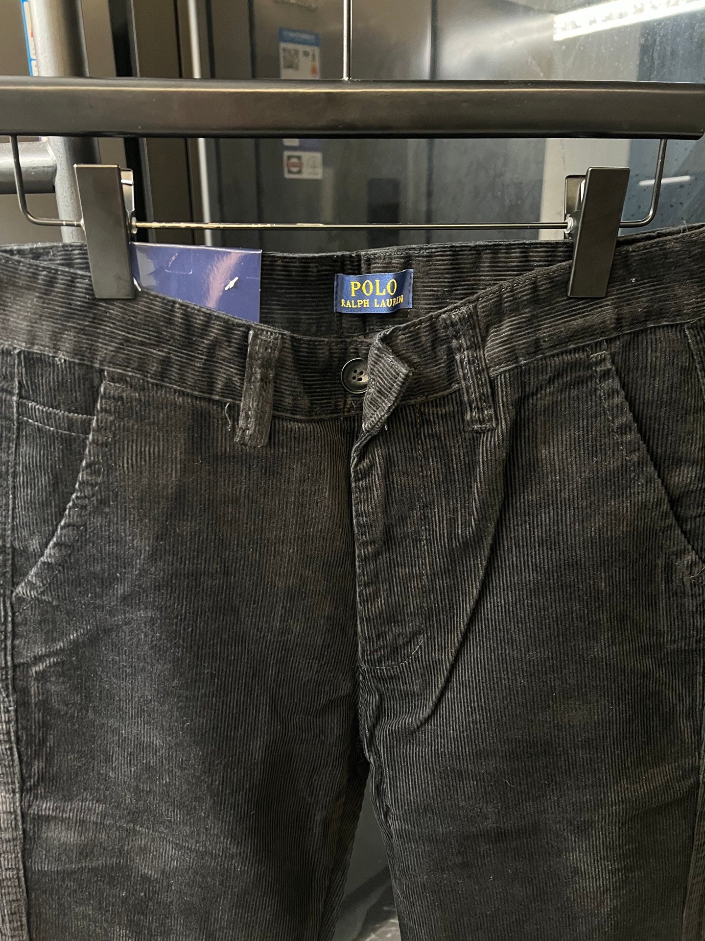 Corduroy jeans waistband with button fly, belt loops, and brand patch