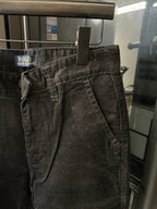 Dark corduroy jeans with belt loops and stitched front creases