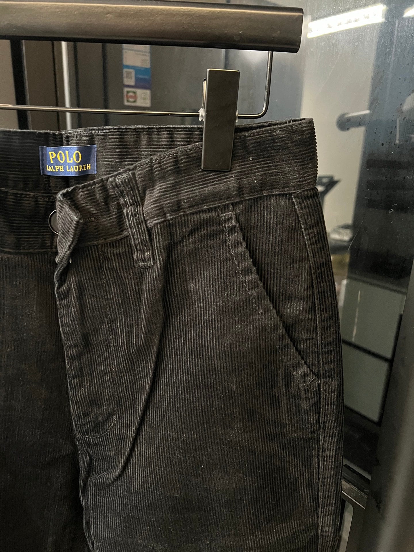 Dark corduroy jeans with belt loops and stitched front creases