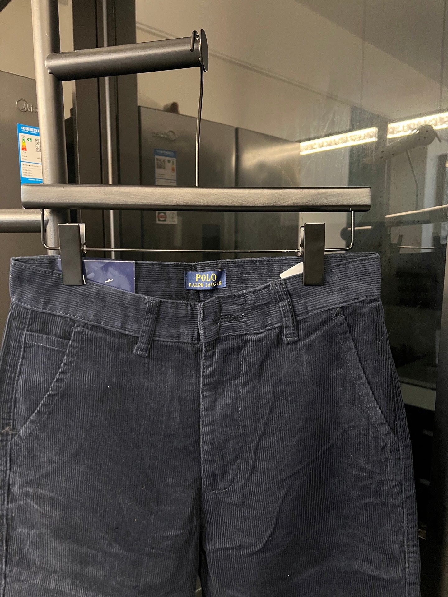 Dark blue denim jeans waist with belt loops and buttoned front