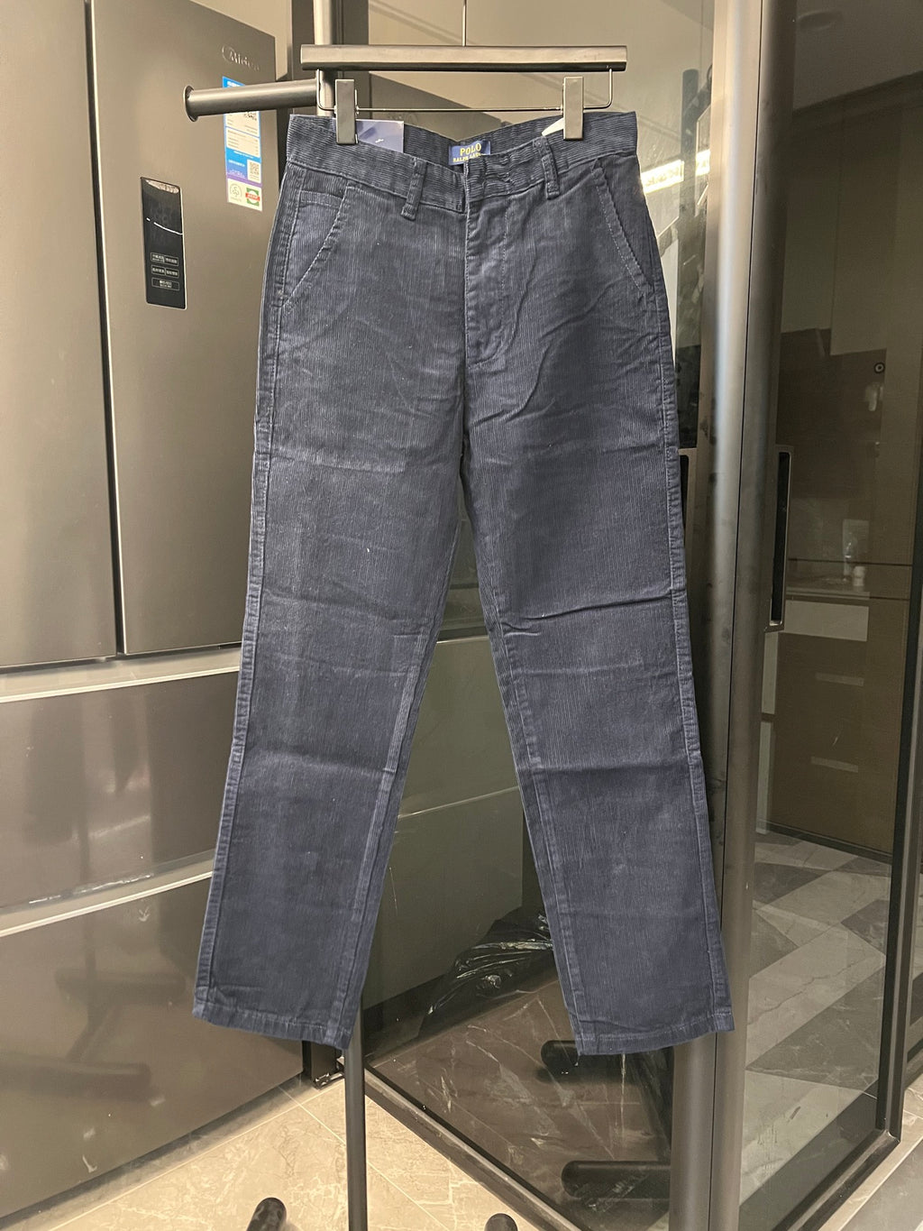 Blue denim straight-leg jeans with front button closure and belt loops
