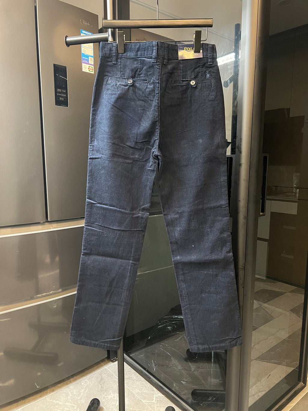 Dark blue denim jeans with fly front, belt loops, and side pockets