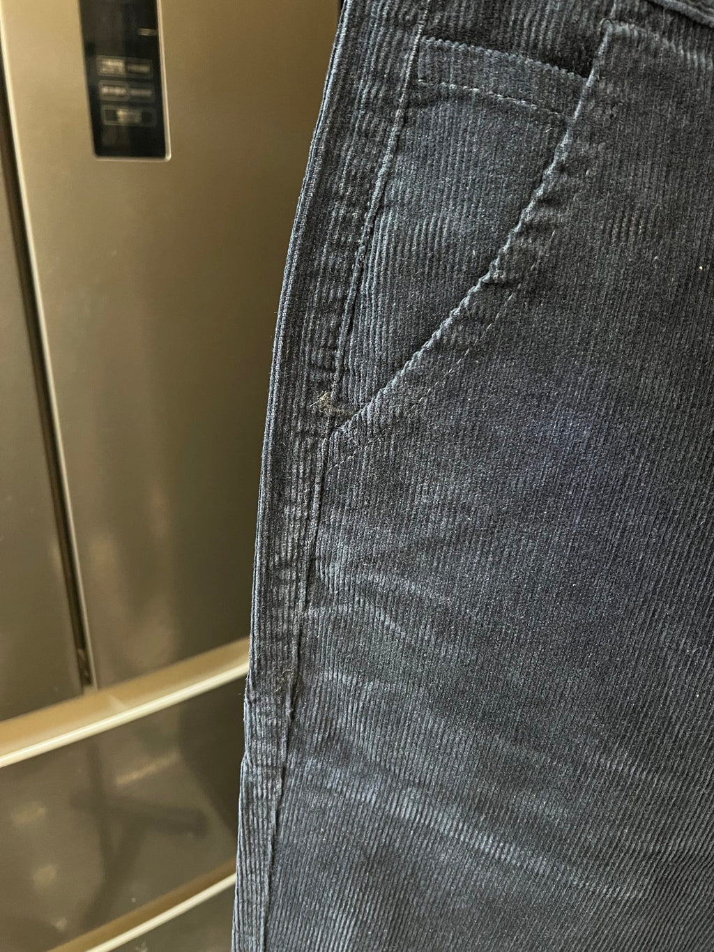 Close-up of denim jeans pocket seam and textured fabric