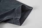 Dark T-shirt short sleeve cuff with visible seam and hem stitching.