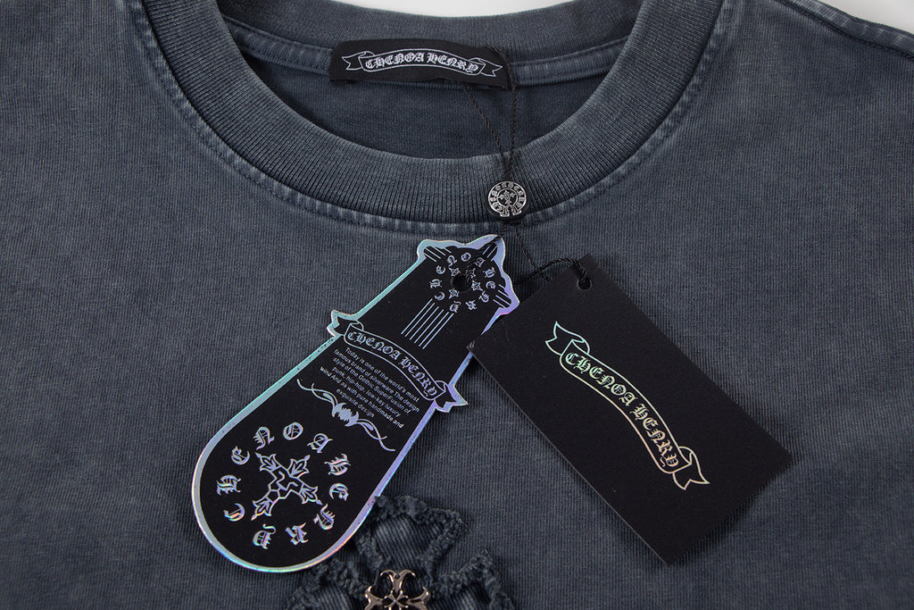 Dark T-shirt neckline with round collar, coin clasp, and inner label.