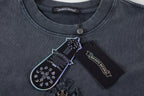 Dark T-shirt neckline with round collar, coin clasp, and inner label.