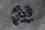Embroidered emblem detail on T-shirt fabric in navy thread