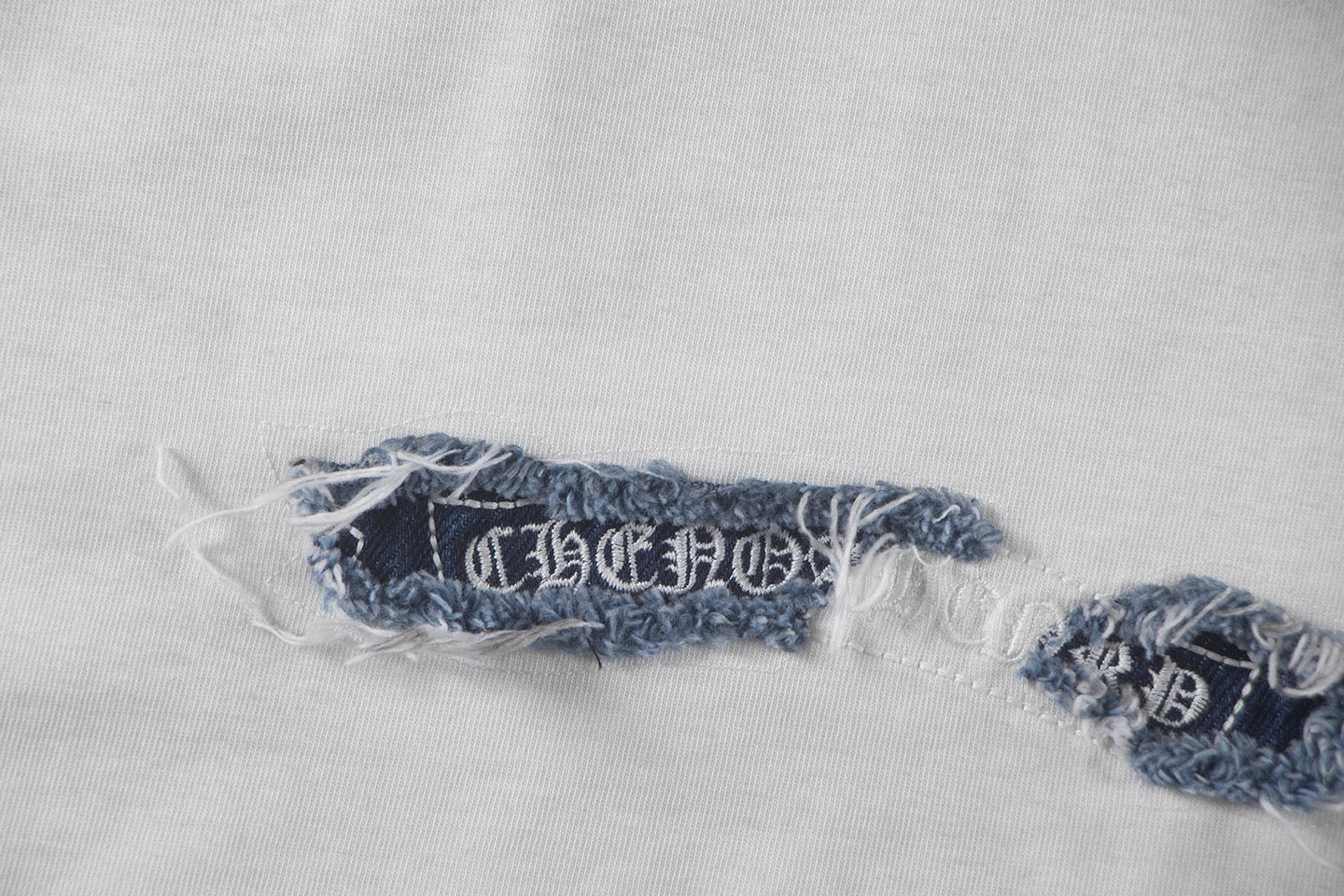Hem embroidery and stitched trim on T-shirt fabric