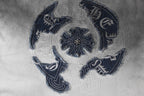 Close-up of navy embroidered crest on gradient T-shirt