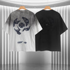 Pair of T-shirts: gradient light gray to white and solid black, each with embroidered emblem