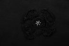 Black short-sleeve T-shirt with circular embroidered emblem on chest