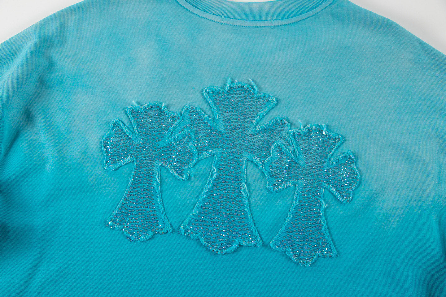 Turquoise T-shirt with large glittery floral chest embroidery