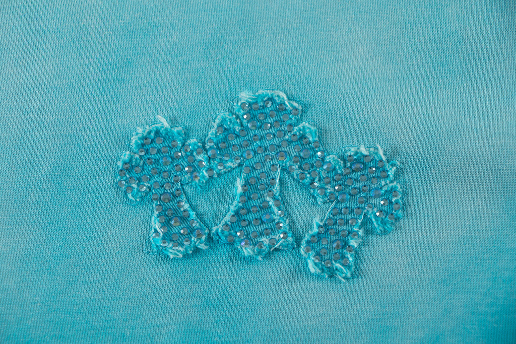 Turquoise T-shirt with glittery floral appliqué motif on front