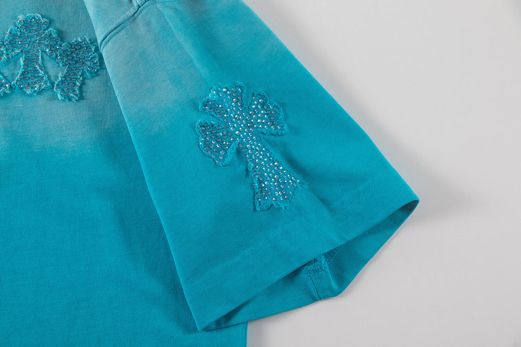 Turquoise T-shirt sleeve with glittery cross applique on cuffs