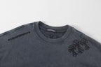 Dark gray graphic T-shirt with chest emblem and small flower detail
