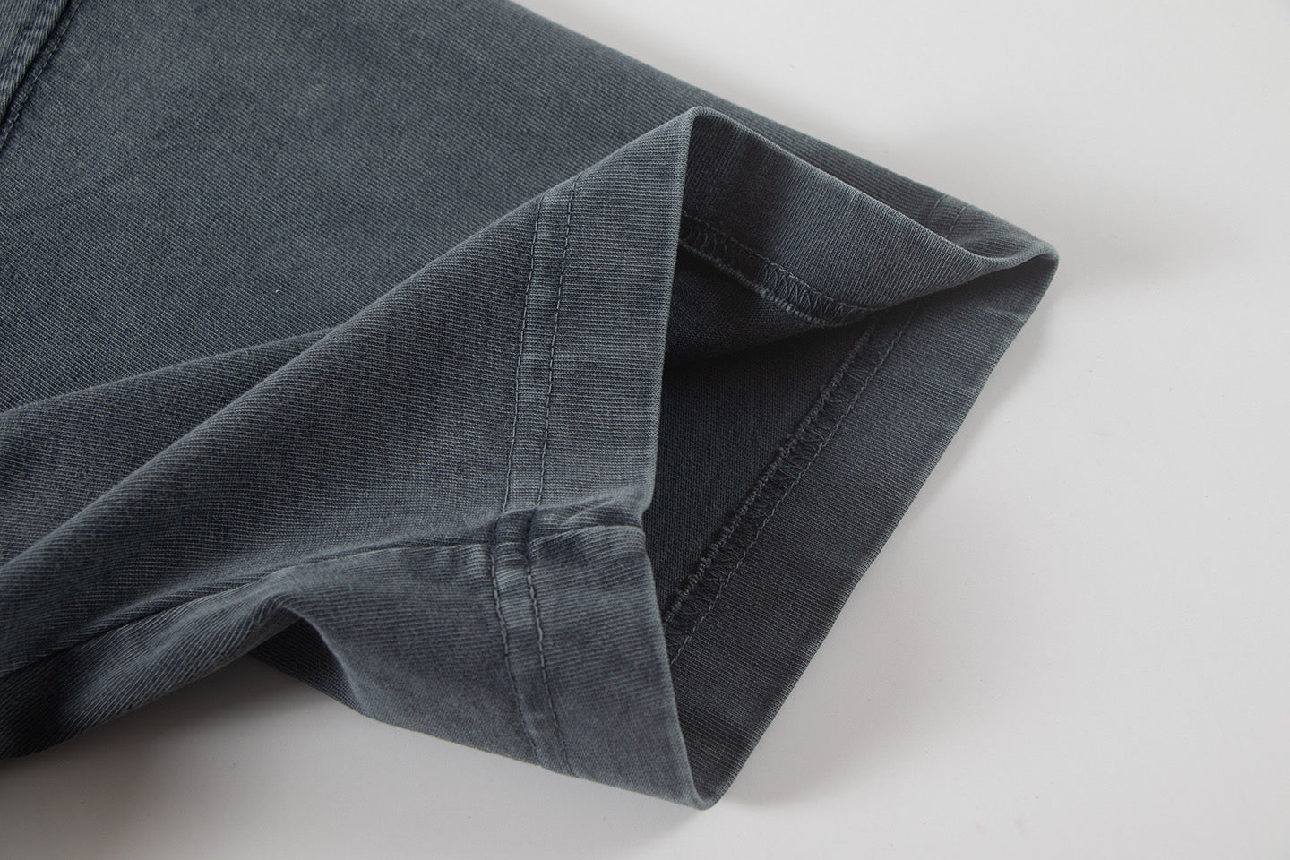 Dark gray T-shirt sleeve and hem seam detail