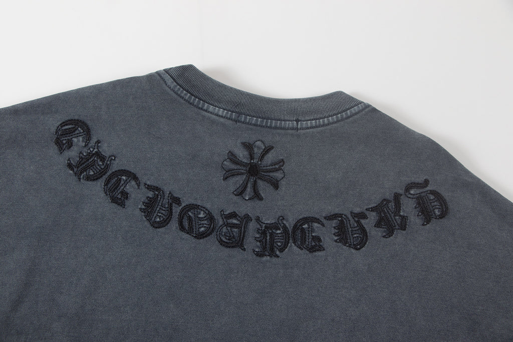 Back of dark gray graphic T-shirt with embroidered lettering and flower icons