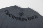 Back of dark gray graphic T-shirt with embroidered lettering and flower icons
