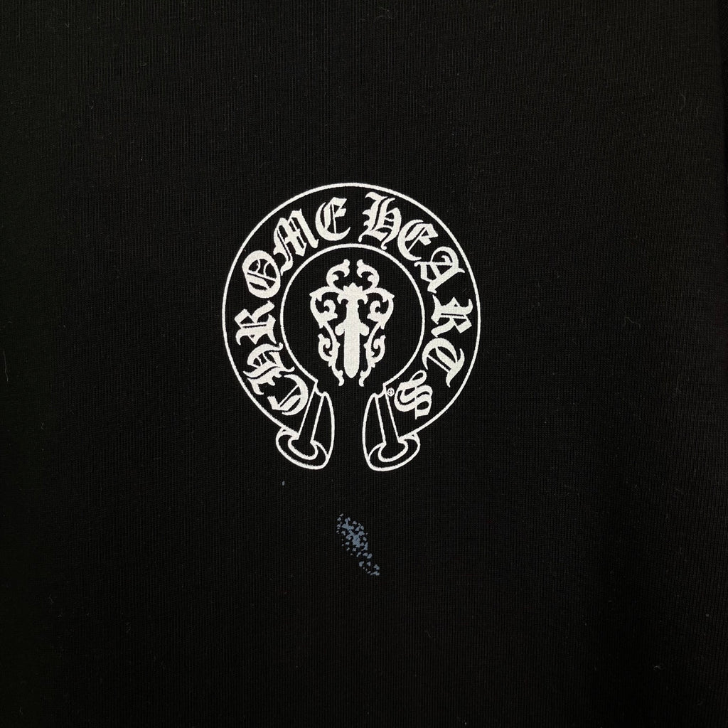 Chrome short-sleeve T-shirt logo detail, white circular emblem on black fabric