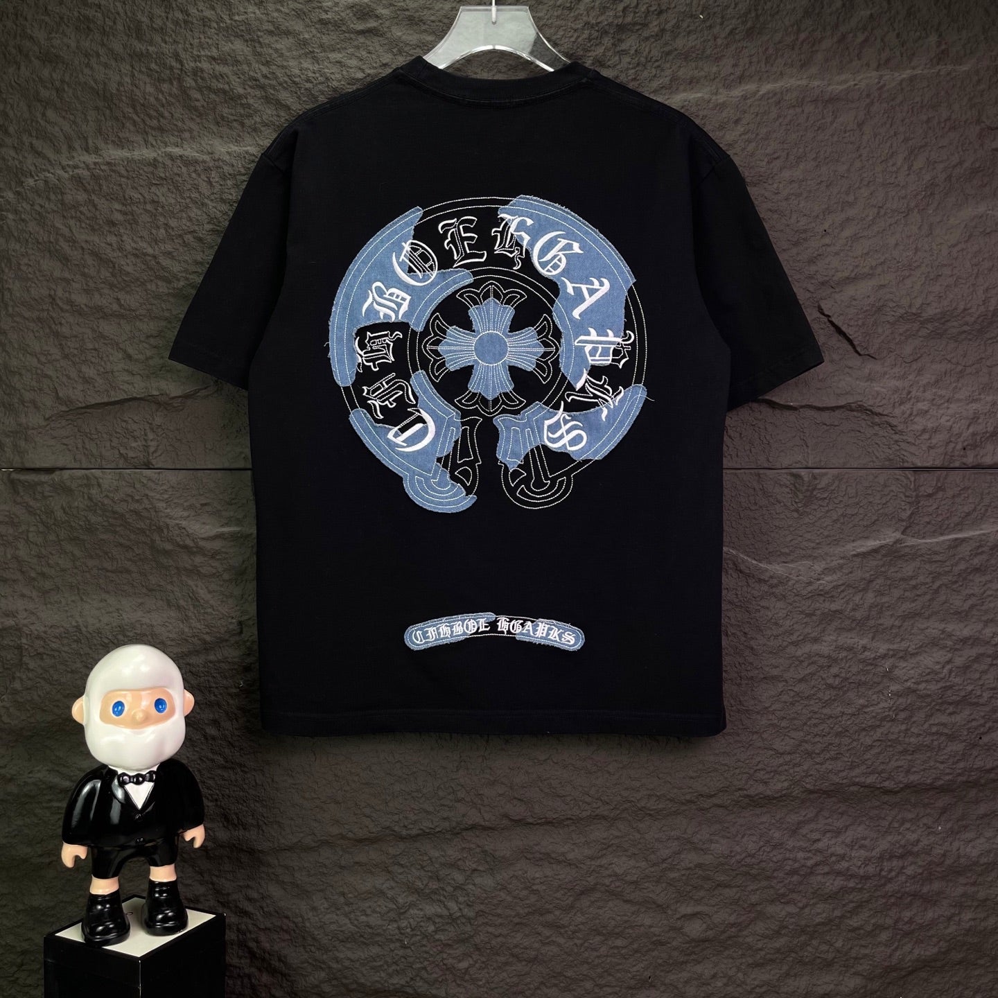 Black short-sleeve T-shirt with large circular light-blue graphic on back