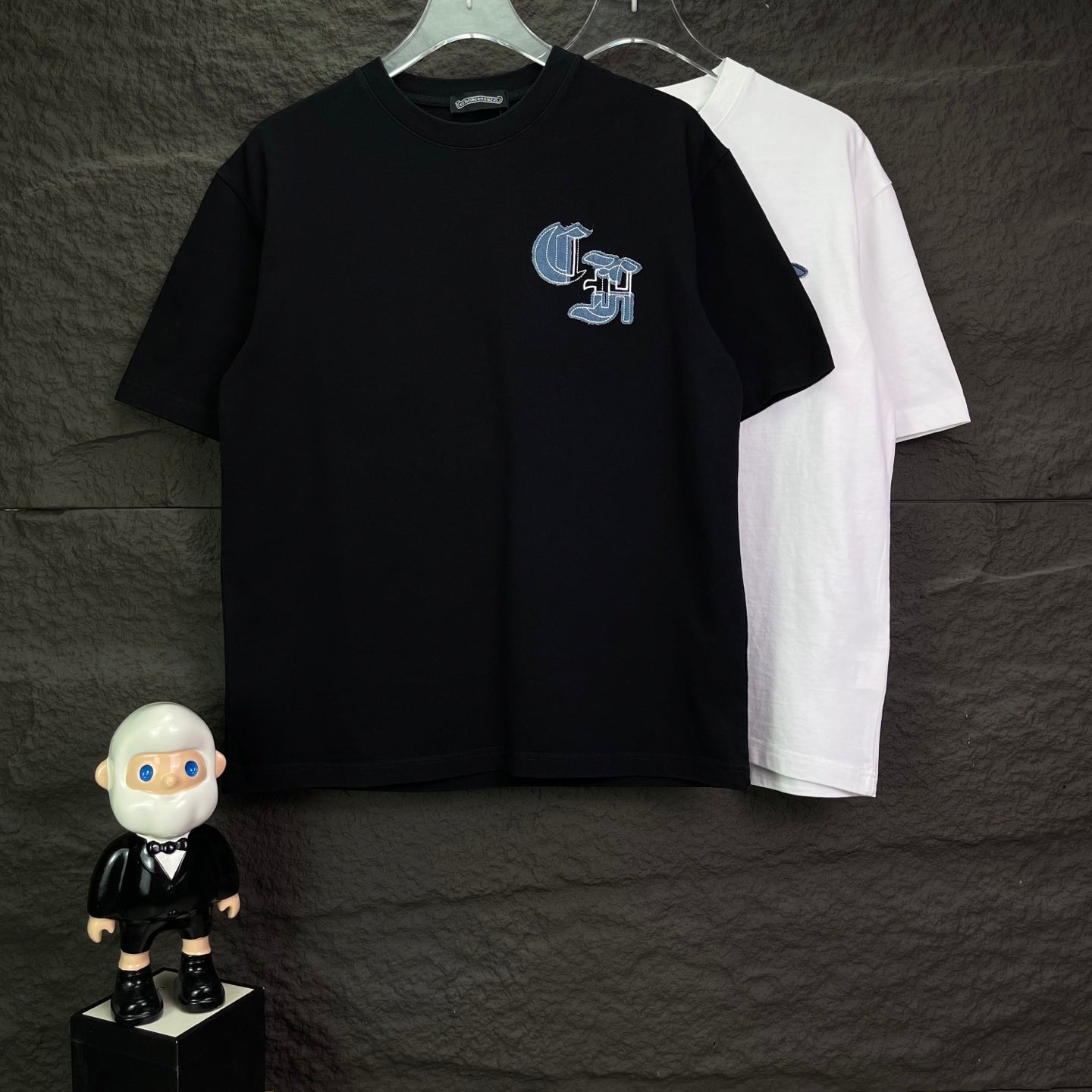 Black short-sleeve T-shirt with small blue logo on left chest