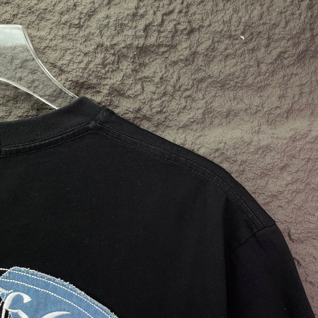 Black T-shirt close-up of back neckline and shoulder seam