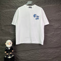White short-sleeve T-shirt with small blue graphic logo on chest