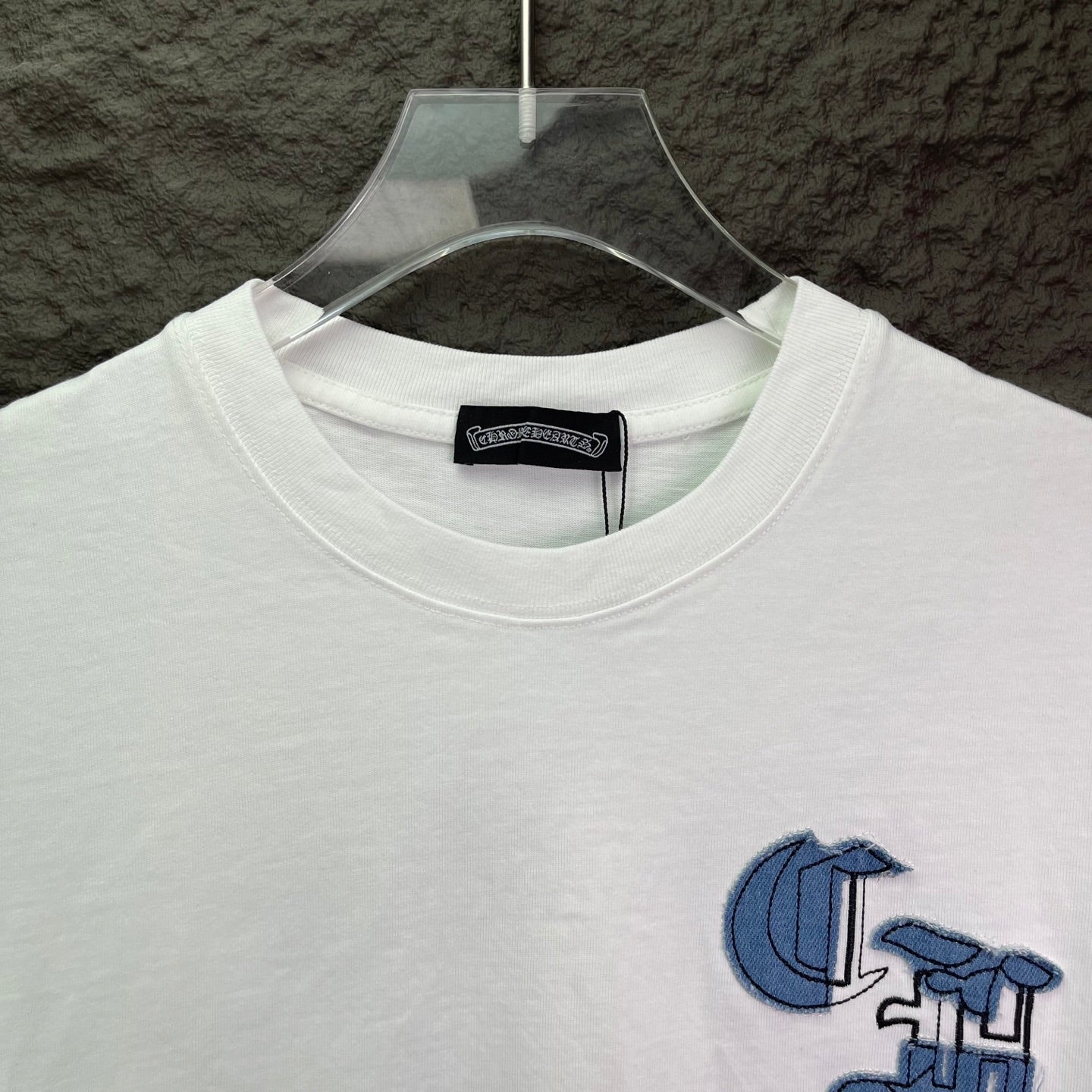 White crewneck T-shirt with blue logo detail and round neckline