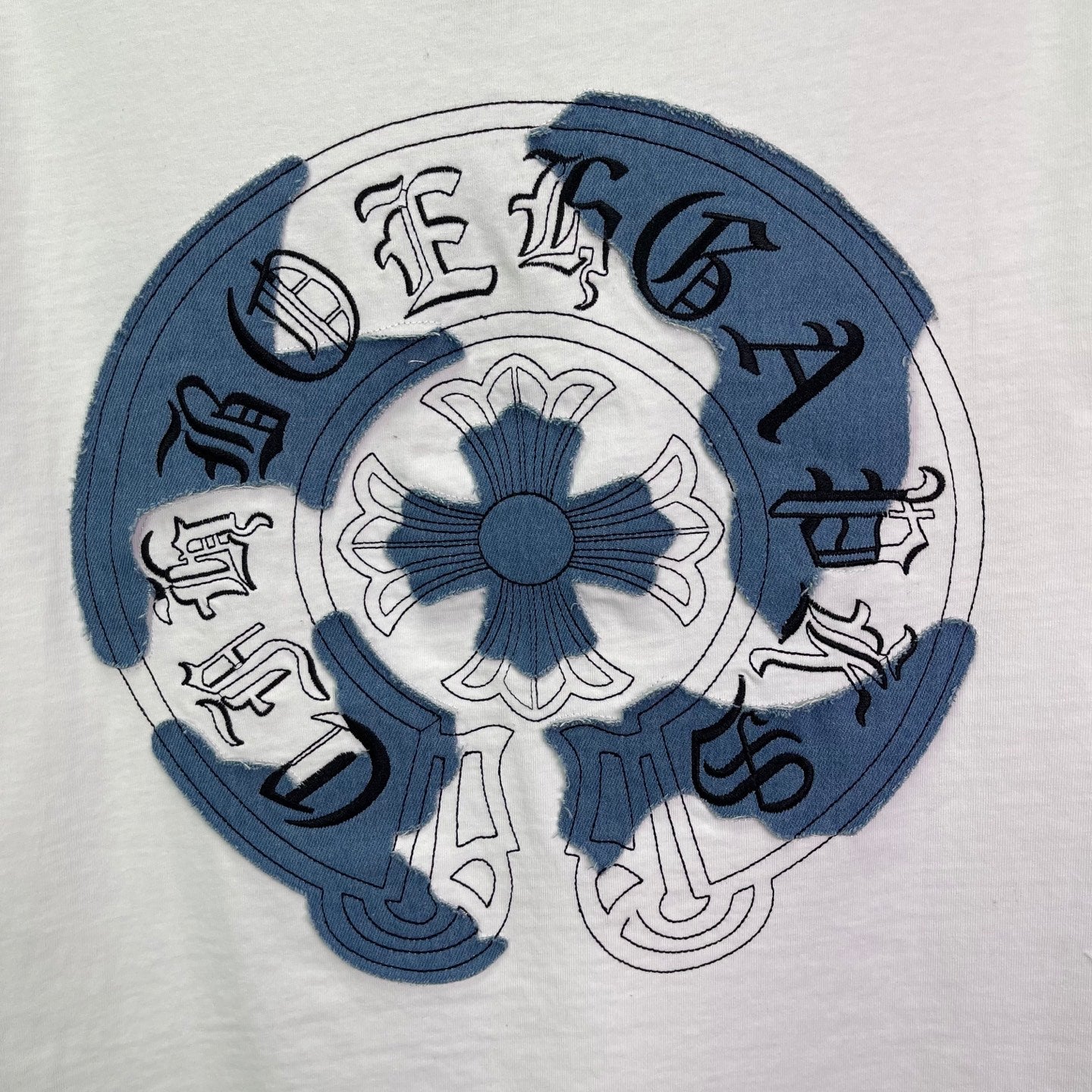 Blue circular back graphic on white T-shirt with stylized symbols