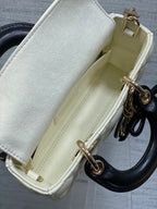 Quilted handbag interior pocket with light lining and gold-tone rings at side