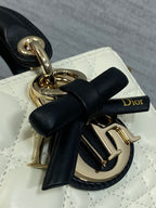 Quilted handbag bow and Dior monogram charm on black-and-white leather