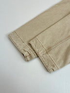 Beige long-sleeve jacket cuff and hem seam detail